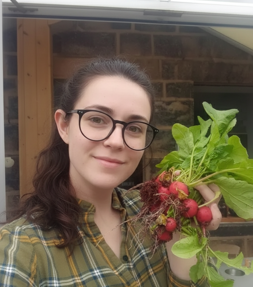 Person holding a bunch of radishes and greens indoors